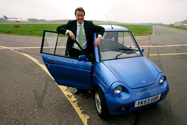 A person standing next to Revai G-Wiz car.