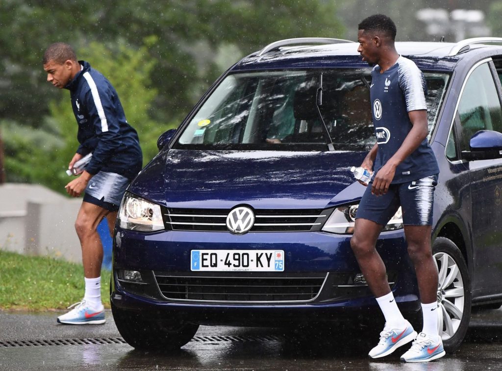 VW Touran with 2 Fresnch soccer players standing by it.